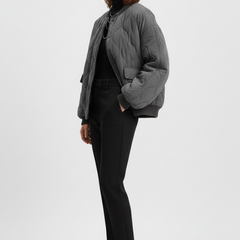 Women's grey bomber jacket by THE WHITMORE FAMILY featuring snap closure and quilted surface, styled for a casual look.