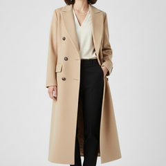 Beige women’s coat by THE WHITMORE FAMILY with lapel collar and button fastening, displayed on a hanger.