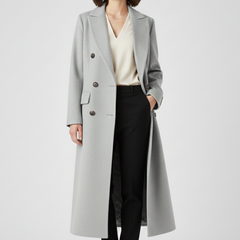 Beige women’s coat from THE WHITMORE FAMILY with a lapel collar and button fastening, stylish and suitable for cold weather.