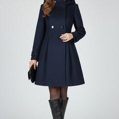 Black women’s coat with hood and double button front from THE WHITMORE FAMILY, featuring a stylish and warm winter outerwear design.