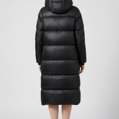Women’s black down coat with hood and quilted surface by THE WHITMORE FAMILY, designed for warmth and style.