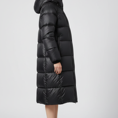 Women’s black down coat with hood and quilted surface by THE WHITMORE FAMILY, stylish insulated outerwear for cold weather.