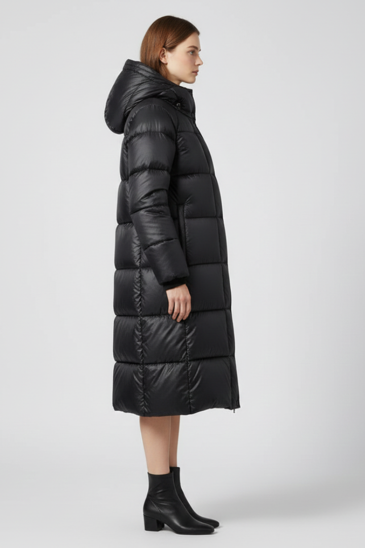 Women’s black down coat with hood and quilted surface by THE WHITMORE FAMILY, stylish insulated outerwear for cold weather.