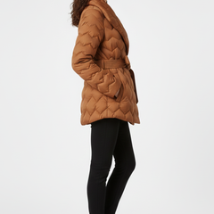 Women’s down coat by THE WHITMORE FAMILY in caramel color, featuring a belted waist and deep pockets for warmth and style.