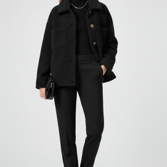 Black women’s fleece jacket by THE WHITMORE FAMILY with buttons and large front pockets, cozy and casual outerwear for women.