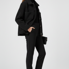 Black women’s fleece jacket by THE WHITMORE FAMILY with button closure and large front pockets, perfect for casual wear.