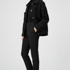 Black women’s fleece jacket by THE WHITMORE FAMILY with button closure and large front pockets, cozy and casual outerwear.