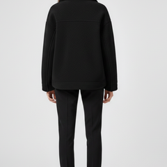 Women’s black fleece jacket by THE WHITMORE FAMILY featuring buttons and large front pockets, perfect for casual wear.