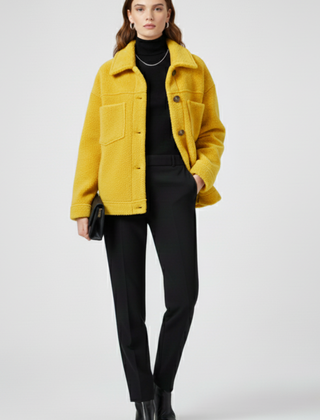 Women’s black fleece jacket by THE WHITMORE FAMILY featuring button closures and spacious pockets, shown on a model.