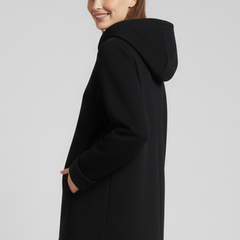 Women’s hooded jacket with zip closure and pockets, from THE WHITMORE FAMILY, shown in a close-up of the front design and fabric.