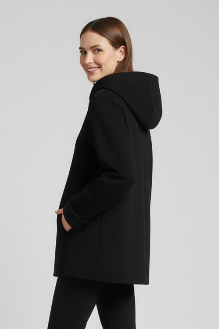 Women’s hooded jacket with zip closure and pockets, from THE WHITMORE FAMILY, shown in a close-up of the front design and fabric.