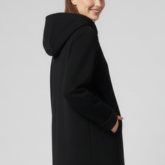 Women’s hooded jacket with front zipper and side pockets, stylish and comfortable outerwear by THE WHITMORE FAMILY.