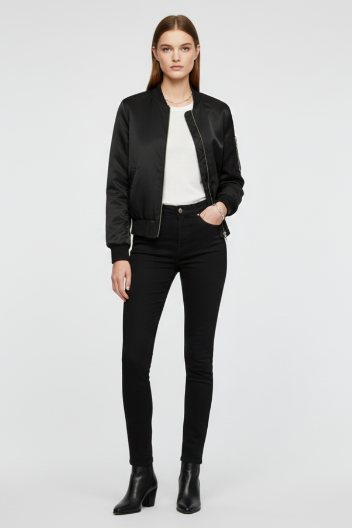 Women’s bomber jacket by THE WHITMORE FAMILY featuring zipper closure and ribbed details, displayed on a hanger.