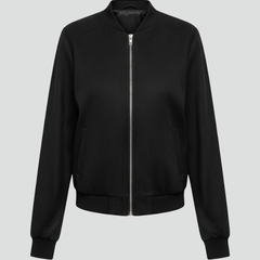 Women’s black bomber jacket by THE WHITMORE FAMILY with zip closure and ribbed edges, shown on a model.