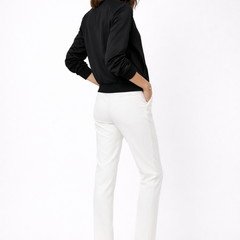 Black women's bomber jacket by THE WHITMORE FAMILY with zip closure and ribbed edges, displayed on a hanger
