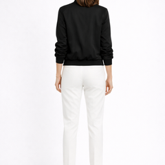 Black women's bomber jacket by THE WHITMORE FAMILY featuring zip closure and ribbed edges, shown from the front.