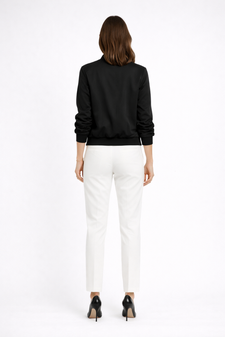 Black women's bomber jacket by THE WHITMORE FAMILY featuring zip closure and ribbed edges, shown from the front.