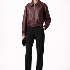 Women’s burgundy bomber jacket by THE WHITMORE FAMILY with zip closure and elasticated hem, stylish women's jacket for casual wear.