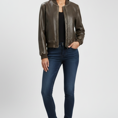 Women's bomber jacket by THE WHITMORE FAMILY with a collared neck and woven outer surface, in a coffee color.