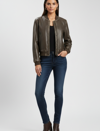 Women's bomber jacket by THE WHITMORE FAMILY with a collared neck and woven outer surface, in a coffee color.
