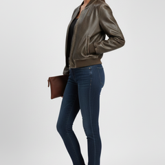 Women's bomber jacket by THE WHITMORE FAMILY with a collared neck and woven outer surface, in a stylish coffee color.