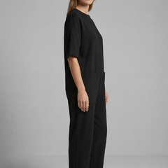Women’s jumpsuit by THE WHITMORE FAMILY featuring a round neck and wide leg trousers, shown in a stylish, comfortable fit.
