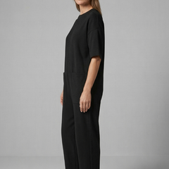 Women’s jumpsuit with round neck and wide-leg trousers from THE WHITMORE FAMILY, stylish and comfortable for casual or dressy wear.