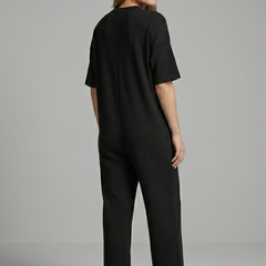 Women’s jumpsuit with round neck and wide-leg trousers by THE WHITMORE FAMILY, featuring a stylish and comfortable design.