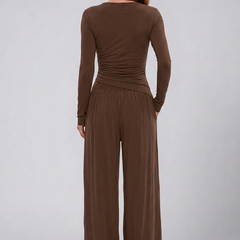 Women's lounge set with wrap top and wide-leg pants, stylish and comfortable jumpsuit by THE WHITMORE FAMILY.