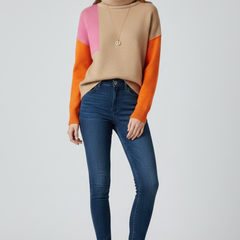 Women’s knit sweater by THE WHITMORE FAMILY featuring a high collar and ribbed cuffs, styled for a cozy, casual look.