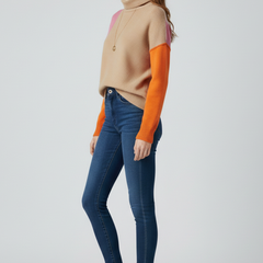 Women’s knit sweater with high collar and ribbed cuffs by THE WHITMORE FAMILY, featuring cozy fabric and stylish design.
