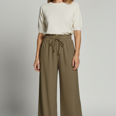 Women’s Palazzo Trousers by THE WHITMORE FAMILY featuring an elastic waist and side pockets, shown in a relaxed, flowy fit.