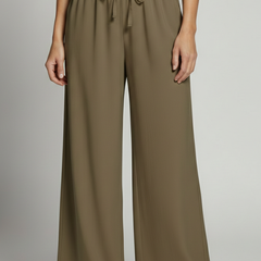 Women's palazzo trousers by THE WHITMORE FAMILY with elastic waist and side pockets, flowy and comfortable for casual wear.