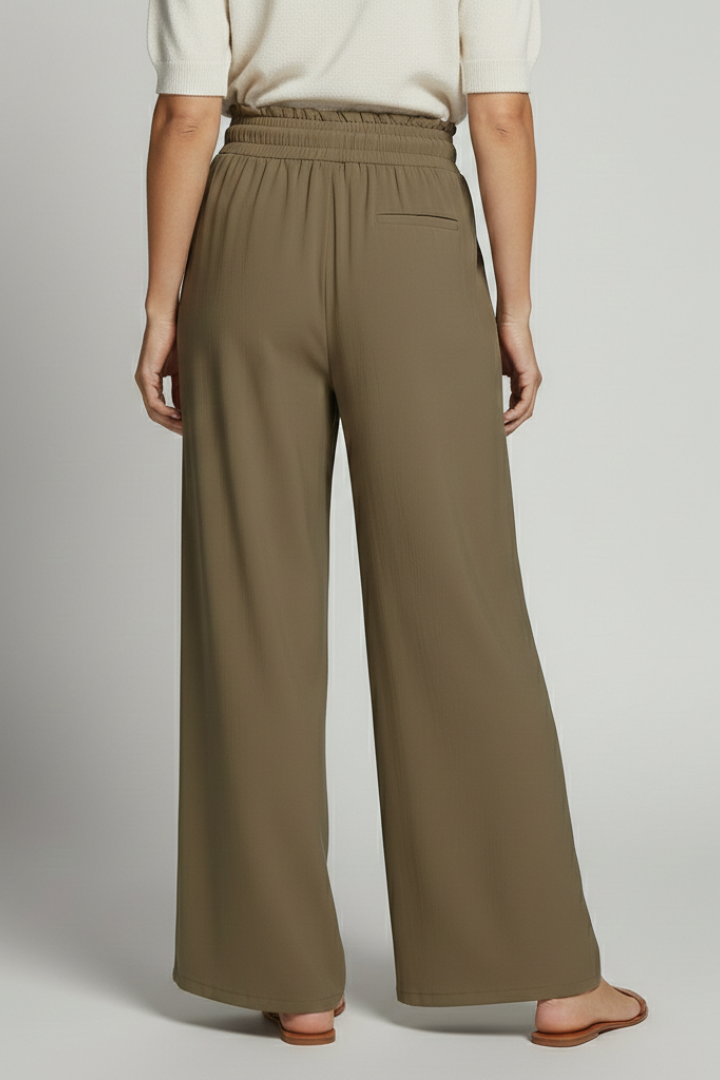 Women’s Palazzo Trousers by THE WHITMORE FAMILY with elastic waist and side pockets, shown in a relaxed fit style.