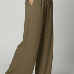 Women’s Palazzo Trousers by THE WHITMORE FAMILY featuring an elastic waist and side pockets, styled in lightweight fabric.