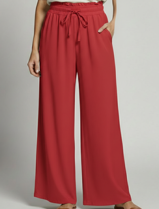Women’s Palazzo Trousers by THE WHITMORE FAMILY with elastic waist and side pockets, shown in a relaxed fit and stylish design.