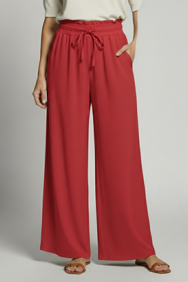 Women’s Palazzo Trousers by THE WHITMORE FAMILY with elastic waist and side pockets, shown in a relaxed fit and stylish design.