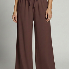 Women’s Palazzo Trousers with elastic waist and side pockets, featuring flowy fabric and a relaxed fit by THE WHITMORE FAMILY.