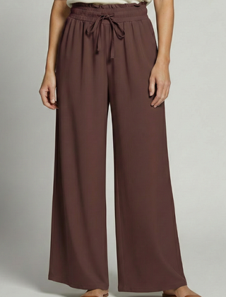 Women’s Palazzo Trousers with elastic waist and side pockets, featuring flowy fabric and a relaxed fit by THE WHITMORE FAMILY.