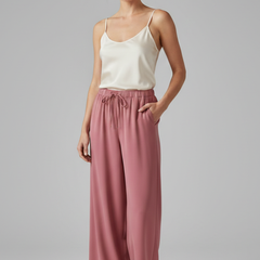 Pink women’s Palazzo trousers with elastic waistband and side pockets by THE WHITMORE FAMILY, styled for casual comfort.