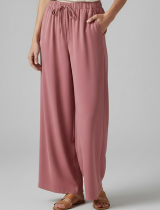 Pink women's Palazzo trousers with elastic waist and side pockets by THE WHITMORE FAMILY, comfortable and stylish for everyday wear.