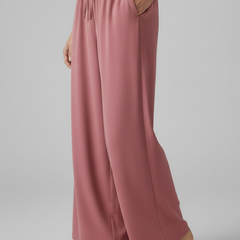 Pink women’s Palazzo trousers with elastic waist and side pockets, stylish and comfortable from THE WHITMORE FAMILY.