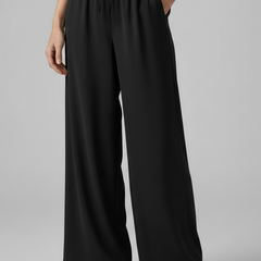 Pink women’s Palazzo trousers by THE WHITMORE FAMILY with elastic waist and side pockets, styled for comfortable, casual wear.