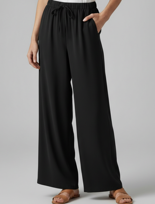 Pink women’s Palazzo trousers by THE WHITMORE FAMILY with elastic waist and side pockets, styled for comfortable, casual wear.