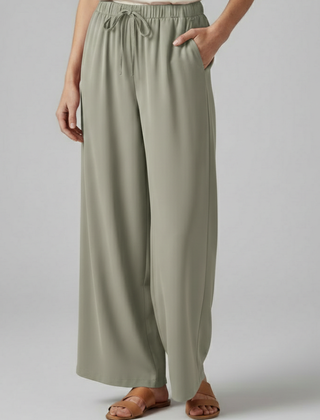 Pink women's Palazzo trousers with elastic waist and side pockets by THE WHITMORE FAMILY, comfortable and stylish for casual wear.