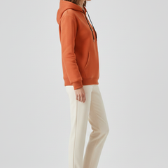 Women’s pullover hoodie with sherpa lining and ribbed cuffs, stylish and cozy sweater from THE WHITMORE FAMILY.