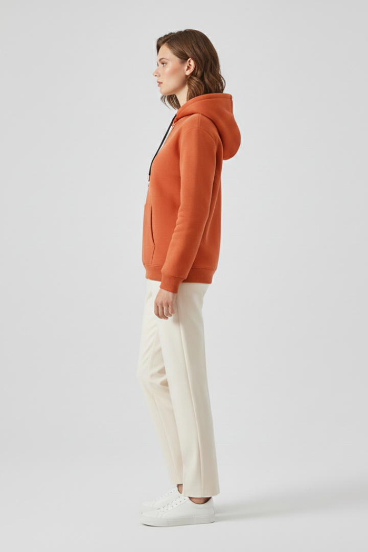 Women's hoodie pullover by THE WHITMORE FAMILY with sherpa lining and ribbed cuffs, shown on a model.