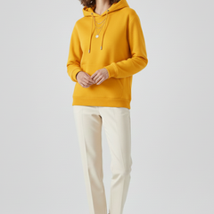 Women’s hoodie pullover by THE WHITMORE FAMILY featuring sherpa lining and ribbed cuffs, displayed on a model.