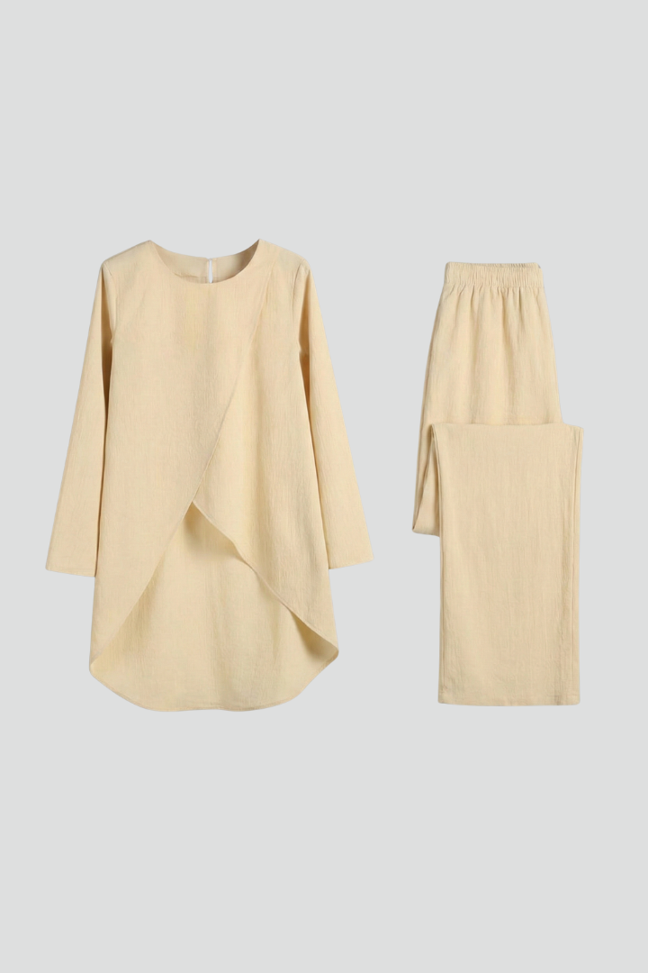 Women’s shirt and trousers set with long sleeves and straight-leg design by THE WHITMORE FAMILY, shown on a model.