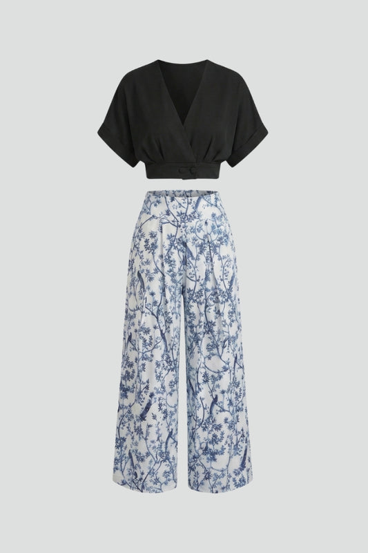 Women’s black two-piece set with V-neck top and wide-leg trousers by THE WHITMORE FAMILY, shown on a model.